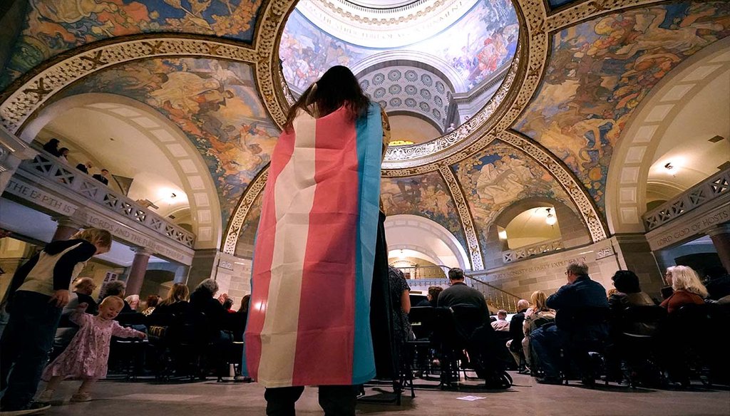 Glenda Starke wears a transgender flag March 20, 2023, as a counterprotest during a rally in favor of a ban on gender-affirming health care legislation at the Missouri Statehouse in Jefferson City, Mo. (AP)